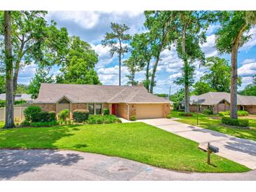 Charming single-story brick home with well-manicured lawn and mature trees offering shade at 2921 Se 38 Pl, Ocala, FL 34480
