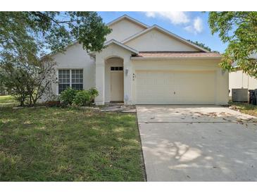 Charming single-Gathering home features a two-car garage, well-manicured lawn, and neutral exterior paint at 442 Graystone Blvd, Davenport, FL 33837