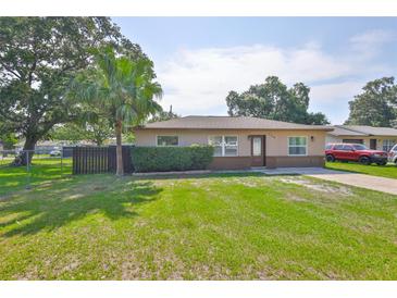 Charming single-story home with a well-manicured lawn and mature trees at 1110 Waterview E Blvd, Lakeland, FL 33801