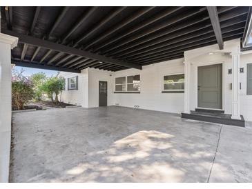 Wide angle view of the concrete carport with covered ceilings leading to the front door of the home at 2800 E Anderson St, Orlando, FL 32803