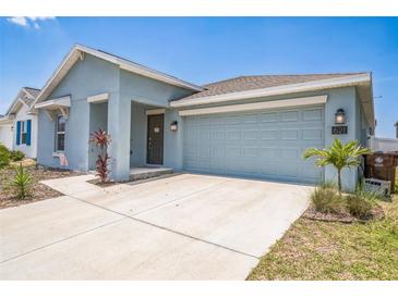 Beautiful one-story home with a large two car garage and well maintained landscaping in the front yard at 621 Silver Palm Dr, Haines City, FL 33844
