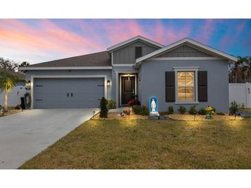 Charming single-story home with manicured lawn, rock garden and a two-car garage at 389 Singing Sands Cir, Lake Wales, FL 33859