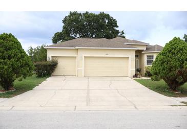 Charming single-Gathering home with a three-car garage and well-maintained landscaping at 7055 Heatherbrook Dr, Lakeland, FL 33809