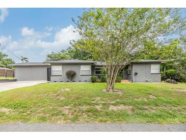 Charming single-story home with a well-maintained lawn and mature trees creating a welcoming curb appeal at 3120 S Polk Ave, Lakeland, FL 33803