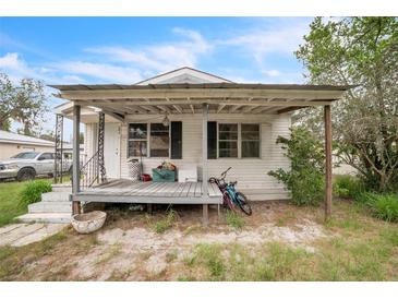 Charming single-story home featuring a covered front porch and a low-maintenance yard at 303 Clayton Rd, Auburndale, FL 33823
