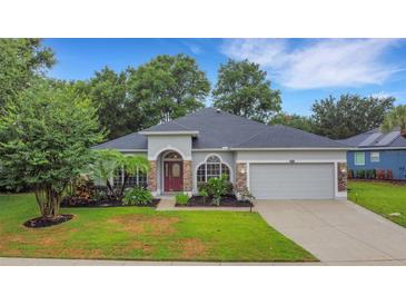 Charming single-story home with well-manicured lawn and mature landscaping at 3897 Beacon Ridge Way, Clermont, FL 34711