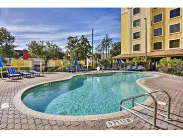 Inviting outdoor pool area surrounded by lounge chairs for relaxation and sunbathing at 7601 Canada Ave # 220, Orlando, FL 32819