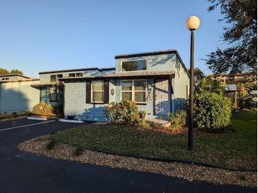 Charming light blue exterior with decorative landscaping and black shutters offers appealing curb appeal at 85 Heather Point Ct # 850, New Smyrna Beach, FL 32169