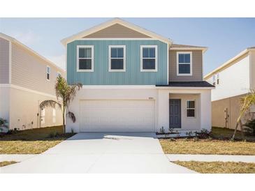 Charming two-story home featuring a two-car garage and colorful exterior paint at 742 Ambleside Dr, Haines City, FL 33844