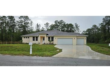 Charming single-story home featuring a three-car garage and neutral color palette, complemented by a well-manicured lawn at 19041 Mardi Gras St, Orlando, FL 32833