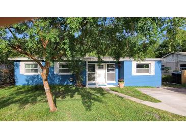 Charming single-story home with a well-maintained lawn and mature landscaping at 2506 Bonneville Dr, Orlando, FL 32826