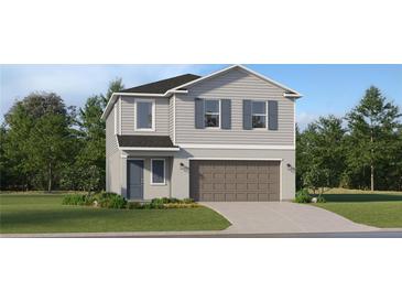 Two-story home features a two-car garage, neutral siding, and a well-manicured front yard at 991 Hour Glass Rd, Lakeland, FL 33801