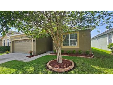 Charming single-story home featuring a well-manicured lawn and inviting curb appeal with a quaint landscape design at 2528 Ladoga Dr, Lakeland, FL 33805