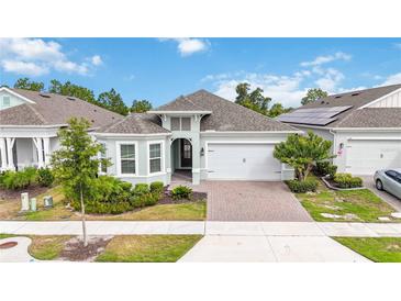 Charming single-story home with a two-car garage, lush landscaping, and a welcoming front entrance at 2132 Limestone Trl, Kissimmee, FL 34747