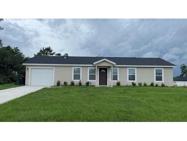 Charming single-story home with a well-maintained lawn, a one-car garage, and a welcoming front entrance at 16910 Sw 27 Avenue, Ocala, FL 34473
