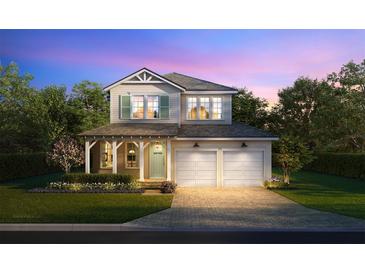 Charming two-story home with a covered porch, a two-car garage, and a beautifully landscaped front yard at 1807 Magnolia Ave, Winter Park, FL 32789