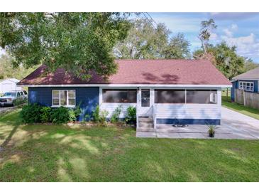 Charming single-story home featuring a cozy front porch and well-maintained lawn at 1938 E Fern Rd, Lakeland, FL 33801
