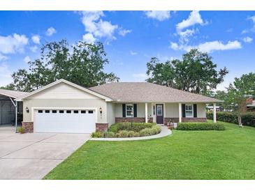 Charming single-story home featuring a well-manicured lawn, attached two-car garage and inviting front porch at 93 Bream St, Haines City, FL 33844