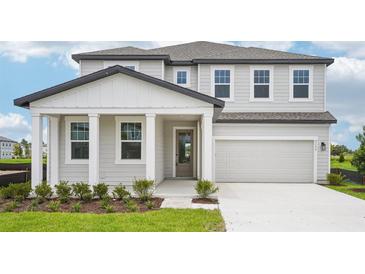Charming two-story home with landscaped yard, covered porch, and attached two-car garage at 2199 Broadbrook Drive, St Cloud, FL 34771