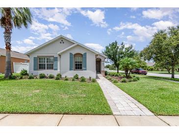 Charming single-story home featuring a beautifully landscaped front yard and a welcoming walkway at 3321 Pintello Ave, New Smyrna Beach, FL 32168