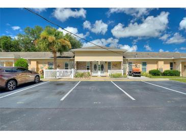 Charming condo with beautiful landscaping, designated parking, and a manicured lawn at 4709 Club Cir, Lakeshore, FL 33854