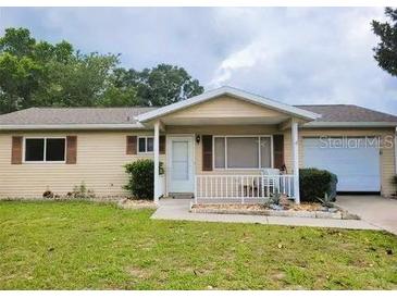 Charming single-story home features a well-maintained front yard and a welcoming covered entrance at 8386 Sw 105Th Pl, Ocala, FL 34481