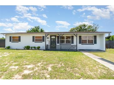 Charming single-story home featuring a cozy front porch and a well-maintained lawn at 811 Casselberry Dr, Lake Wales, FL 33853