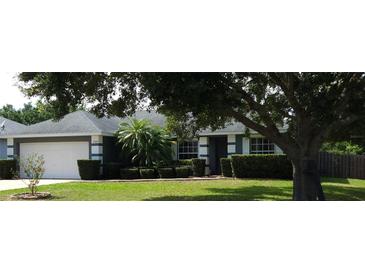 Charming single-story home featuring well-manicured landscaping and an attached two-car garage at 2509 Montecito Ave, Eustis, FL 32726