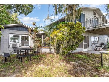 View of the exterior of a single-Gathering home with a patio table and chairs at 1149 Shady Cove E Rd, Haines City, FL 33844