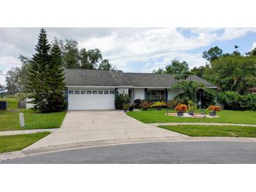 Charming single-story home features a well-manicured front yard and a two-car garage at 7607 Benji Ridge Trl, Kissimmee, FL 34747