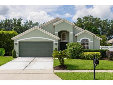 Charming home featuring a well-manicured lawn, an attached two-car garage, and inviting curb appeal at 643 Blenheim Loop, Winter Springs, FL 32708