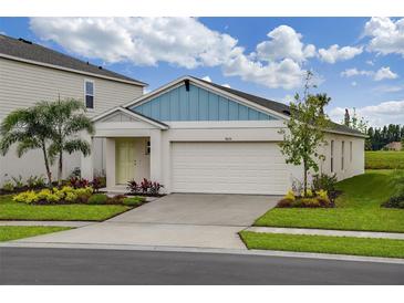 Charming single-Gathering home with a two-car garage, green lawn, and well-maintained landscaping at 762 Ambleside Dr, Haines City, FL 33844