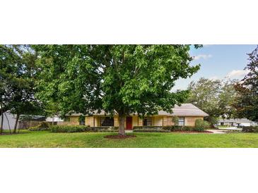 Charming single-story home with a well-maintained lawn and mature trees offering shade at 6642 Parson Brown Dr, Orlando, FL 32819