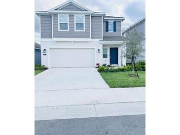 Charming two-story home with a well-maintained lawn and a classic architectural design at 2847 Big Sur Rd, Davenport, FL 33837