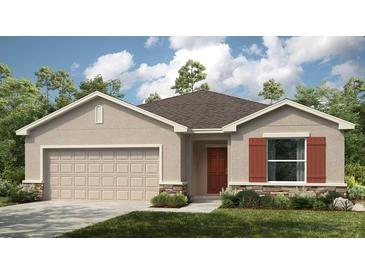 Charming single-story home with a two-car garage and well-maintained lawn at 2072 Babbling Brook Blvd, Auburndale, FL 33823
