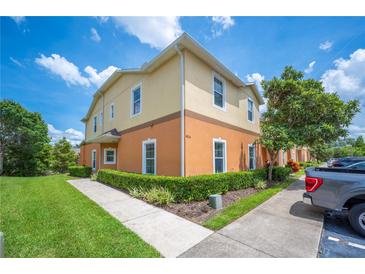 Two-story home featuring a well-kept lawn, mature landscaping, and a two-tone exterior paint scheme at 4034 Winding Vine Dr, Lakeland, FL 33812