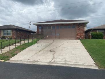 Cozy single-story home featuring brick facade, attached garage, and a convenient driveway at 661 Lake Carolyn Cir, Lakeland, FL 33813