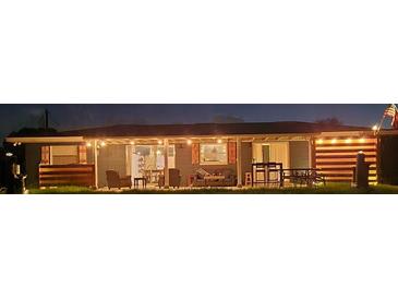 A well lit backyard provides additional space for gathering and entertaining at 4119 Chambers St, Lake Wales, FL 33898