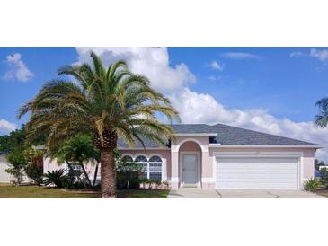 Charming single-story home with a well-manicured lawn, mature palm trees, and a two-car garage at 2514 Sage Dr, Kissimmee, FL 34758