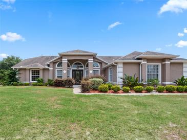 House exterior featuring a large front yard and landscaping at 32200 Ponderosa Ave, Deland, FL 32720