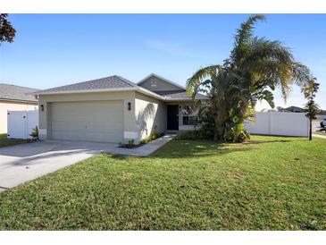 One-story house with attached garage and a well-maintained lawn at 3435 Arabesque Dr, Deland, FL 32724