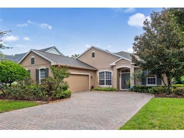 Single-story home with a two-car garage and landscaped yard at 210 Brookgreen Way, Deland, FL 32724