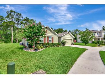 Charming single-Gathering home with manicured lawn, beautiful landscaping, and inviting curb appeal at 317 Nowell Loop, Deland, FL 32724