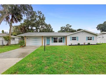 Charming ranch home with freshly painted exterior and landscaped lawn at 1412 Ruthbern Rd, Daytona Beach, FL 32114