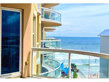 Stunning ocean view from a condo balcony with glass railings, perfect for relaxing and enjoying the beach scenery at 3703 S Atlantic Ave # 501, Daytona Beach Shores, FL 32118