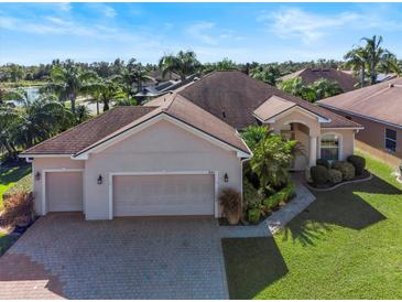 Single-story home with two-car garage and landscaped yard at 4345 Heath Land Ln, Lake Wales, FL 33859