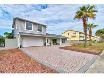 Charming single-Gathering home with a brick driveway and mature landscaping at 4766 S Atlantic Ave, Ponce Inlet, FL 32127