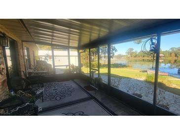 Relaxing screened porch overlooking a tranquil lake at 507 Dade Ct, Deltona, FL 32725