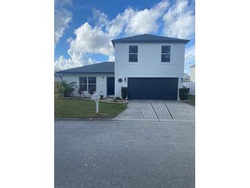 Two-story house with a modern facade and a two-car garage at 7810 Country Chase Ave, Lakeland, FL 33810