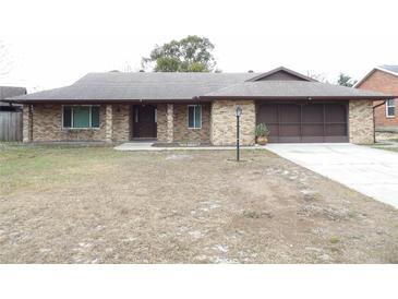Brick ranch house with carport and mature landscaping at 641 Fairhaven St, Deltona, FL 32725